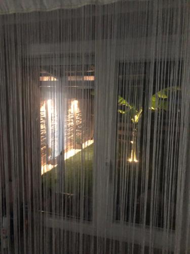 a view of a window with curtains on it at Sunny Garden Apartment in Bogács