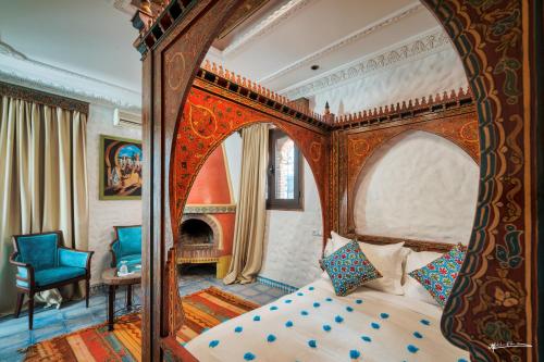 a bedroom with a canopy bed with a fireplace at Casa Hassan in Chefchaouene