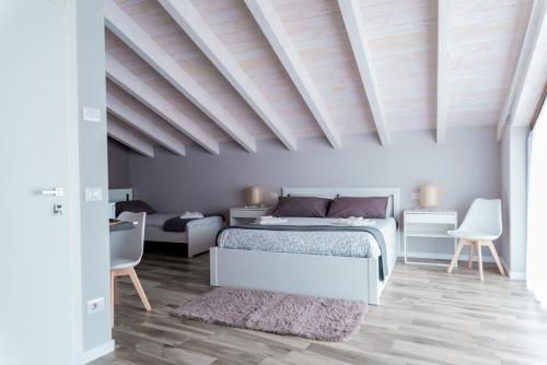 a bedroom with a bed and a table and chairs at Via Mazzini B & B (MXP) in Vizzola Ticino