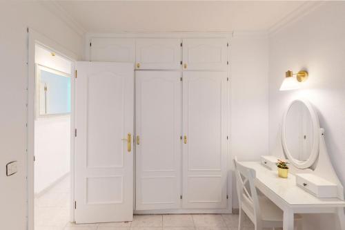 a white bathroom with a sink and a mirror at Sunny Apartment Tanife by Yumbo in Playa del Ingles