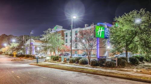 a building with a sign on the side of a street at Holiday Inn Express Hotel & Suites Gulf Shores by IHG in Gulf Shores
