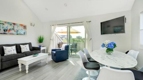 a living room with a table and a couch at Windward Shores in Amagansett