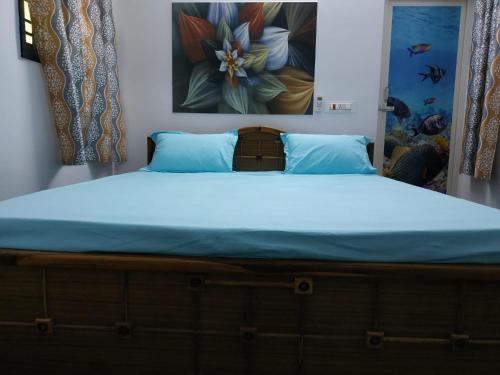 a bedroom with a bed with a blue mattress at Vasantham Villas in Pondicherry