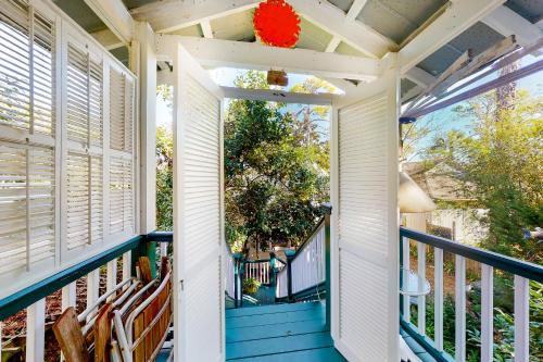 a front porch with a blue and white deck at Baby Breezy Tree House in Demere Park