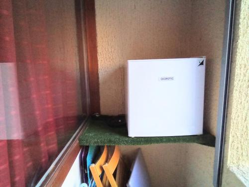 a white box is sitting on a shelf at Studio St Lary village-vue montagne. in Saint-Lary-Soulan