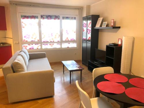 a living room with a couch and a table at Apartamentos Noluna in Segovia