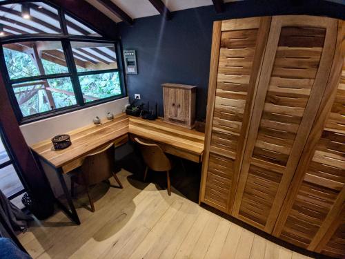 a room with a wooden desk and a window at Uvita Bali Bosque Retreat in Uvita