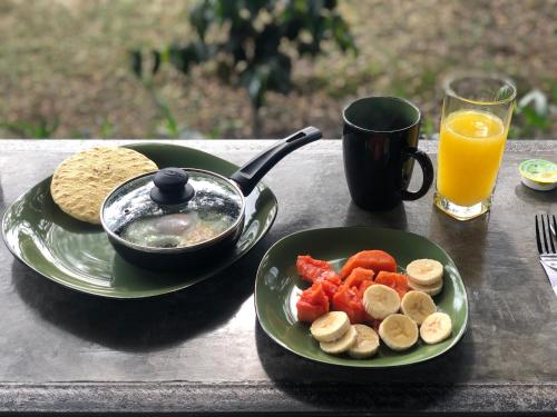 a table with a plate of food and a bowl of fruit at Finca Hotel Brasilia in La Tebaida
