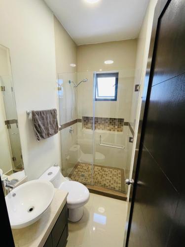 a bathroom with a shower and a toilet and a sink at Suites Santiago in Santiago