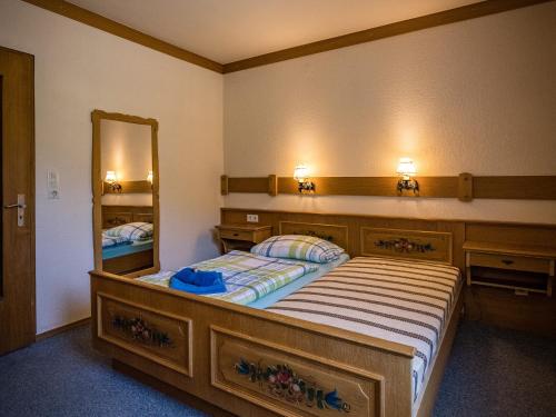 a bedroom with a bed and a large mirror at Hotel- Pension Oechsner in Bad Reichenhall