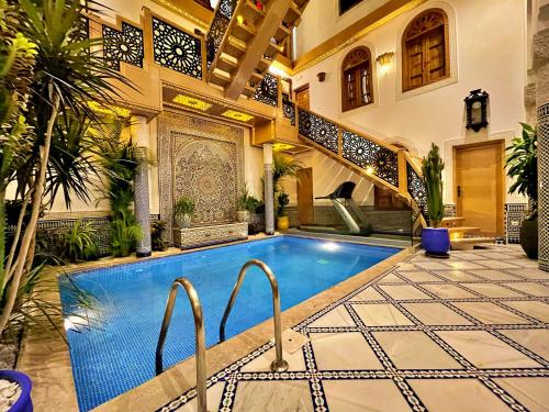 a house with a swimming pool in a courtyard at Riad Marjana suites & Spa in Fès