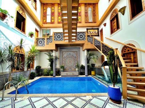 a house with a swimming pool and a staircase at Riad Marjana suites & Spa in Fez