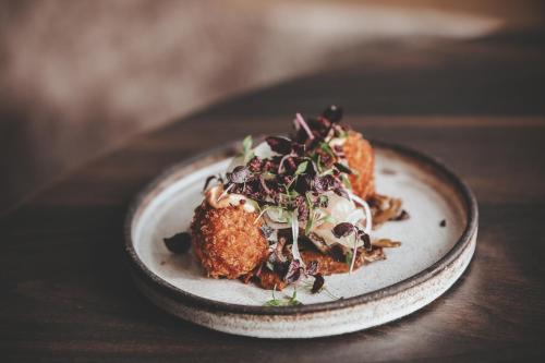a plate of food on a wooden table at Siljansnäs Hotell in Siljansnäs