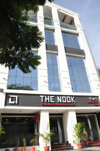 a building with a sign that reads the nook at Hotel The Nook in Madurai