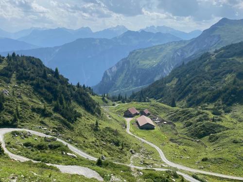 a winding road through a valley in the mountains at Haus Maschol in Wald am Arlberg