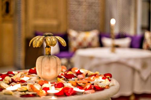 a pizza with fruit and vegetables on a table at Riad Marjana suites & Spa in Fez