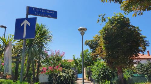 a blue street sign next to a street light at Villa Badi in Umag