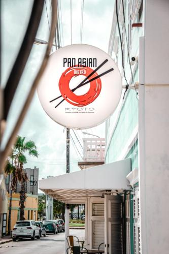 a sign for a restaurant on the side of a building at Bed & Bike Curacao in Willemstad