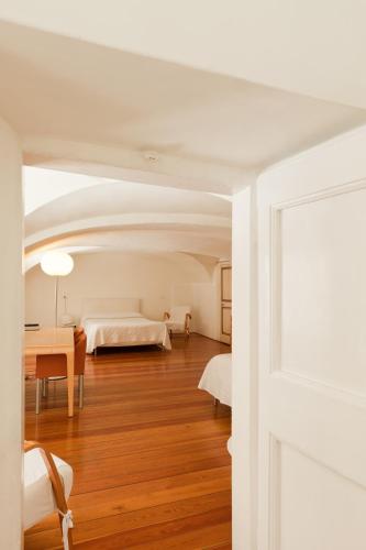 a bedroom with two beds and a table in a room at Palazzo Cicala in Genova