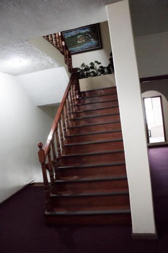 a staircase in a house with a stair case at HOTEL ROMO in Ciudad Hidalgo