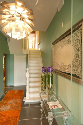 a hallway with a glass table and purple flowers at B&B Saint-Georges -Located in the city centre of Bruges- in Bruges
