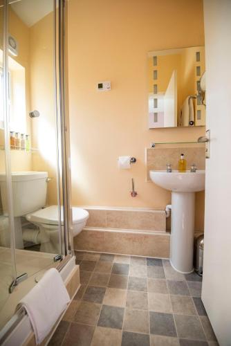 a bathroom with a shower toilet and a sink at Bridleways Guesthouse & Holiday Homes in Mansfield