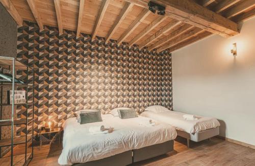a bedroom with two beds with dolls on them at Domaine Sur Les Sarts in Ohey