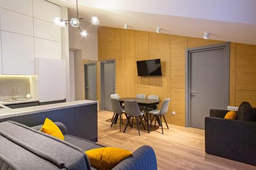 a living room with a couch and a table at 4-Bedroom Luxury Apartment in New Gudauri in Gudauri
