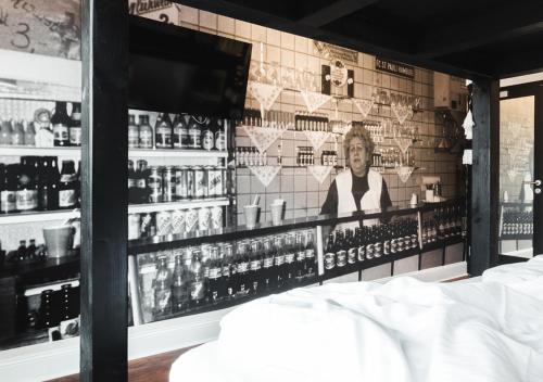 a bar with a picture of a woman on the wall at Pyjama Park St Pauli Hotel und Hostel in Hamburg