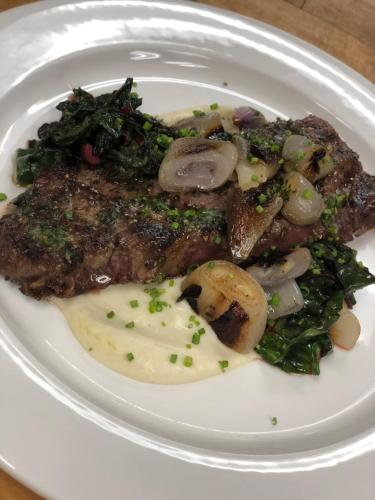 a plate of food with steak and vegetables on it at Hotel Deco in Omaha