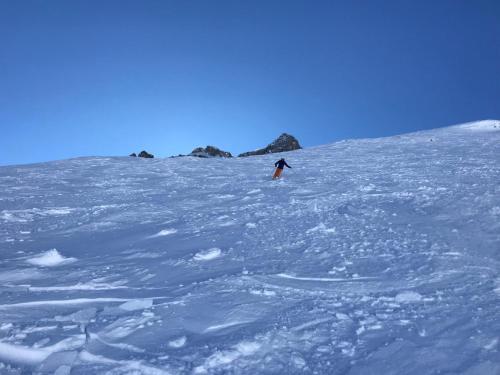 a person riding a snowboard down a snow covered slope at Haus Maschol in Wald am Arlberg
