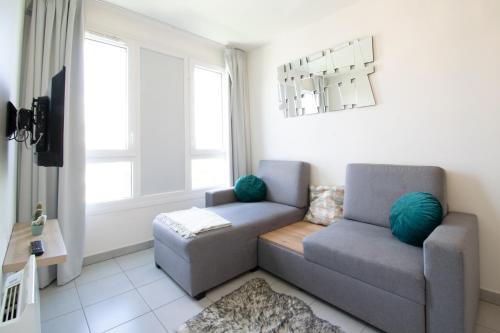a living room with a couch and a chair at °Le métropole° Check in H24/wifi in Lyon