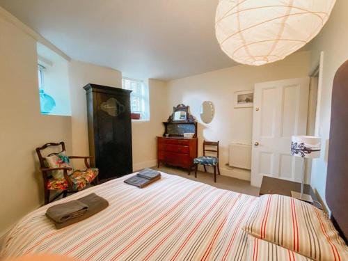 a bedroom with a large bed and a lamp at SUNNYSIDE APARTMENT - Spacious 2 Bedroom Ground Floor with Free Parking In Kendal, Cumbria in Kendal