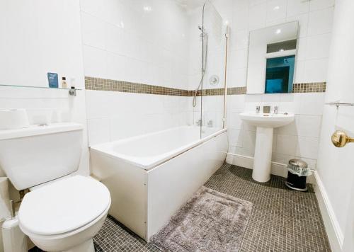 a white bathroom with a toilet and a sink at SUNNYSIDE APARTMENT - Spacious 2 Bedroom Ground Floor with Free Parking In Kendal, Cumbria in Kendal