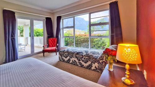 a bedroom with a bed and a large window at Cape Town Lock-and-Go House Ideal for your Holiday in Cape Town