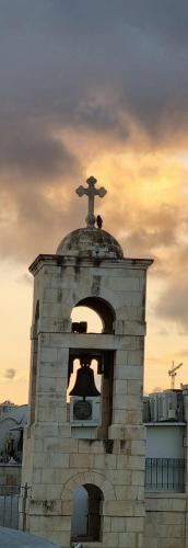 a bell tower with a cross on top of it at New Citadel Hostel in Jerusalem