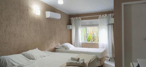 Ένα ή περισσότερα κρεβάτια σε δωμάτιο στο Pousada Nascente Pequena