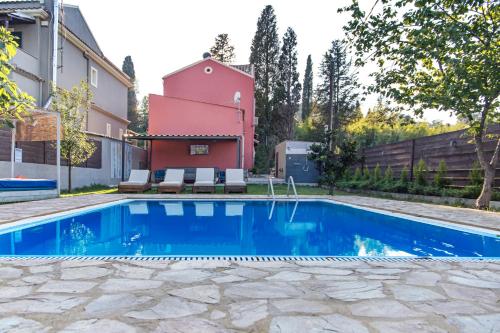 a swimming pool in the backyard of a house at Villa Hermes in Potamós