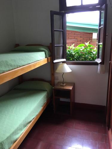 a room with two bunk beds and a window at Hosteria Helvecia in Montecarlo
