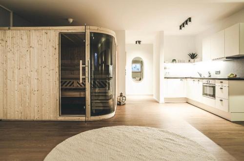 a large kitchen with a large sliding glass door at Oskar Apartments in Neustift im Stubaital