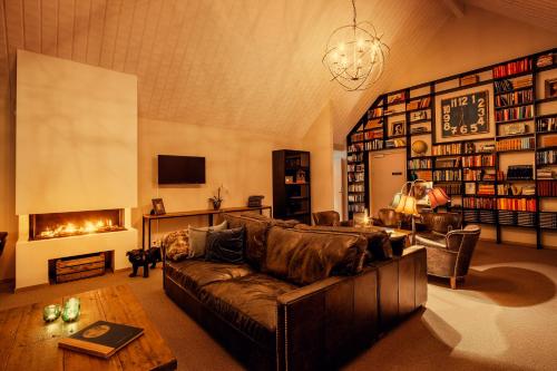 a living room with a couch and a fireplace at Hotell Mossbylund in Abbekås