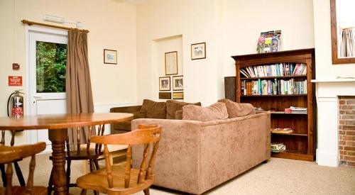 a living room with a couch and a table at YHA Streatley on Thames in Streatley