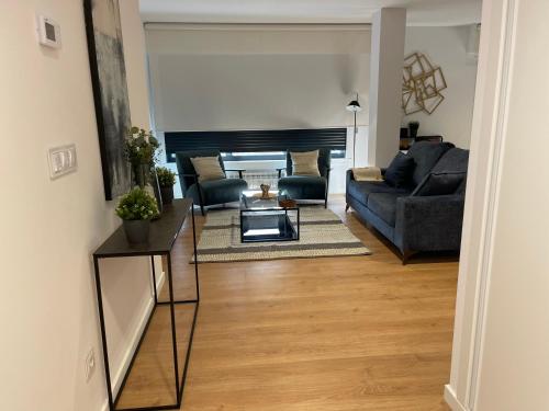 a living room with a couch and a table at Oktheway Areal Terrace in Oleiros