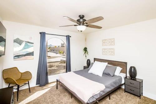 a bedroom with a bed and a ceiling fan at Palm Paradise Water Views Heated Pool & Spa! in Lake Havasu City