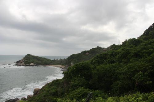 a view of the ocean from a hill at HOSTAL MIRADOR dentro del parque tayrona in El Zaino