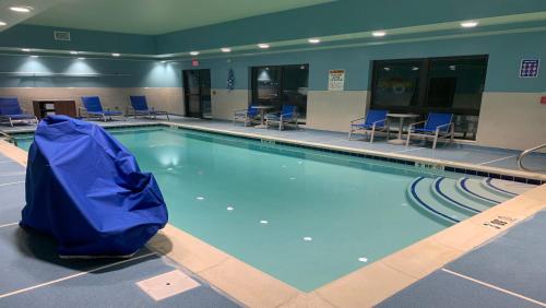 a swimming pool with a blue tarp around it at Holiday Inn Express & Suites - Middletown by IHG in Middletown