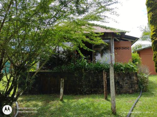 a house with a fence in front of it at Hotel Mirador Osa in Mogos