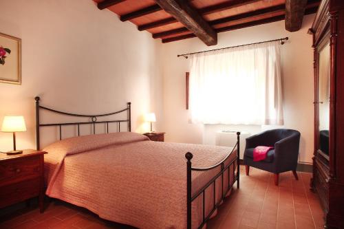 En eller flere senge i et værelse på Agriturismo Il Poggione