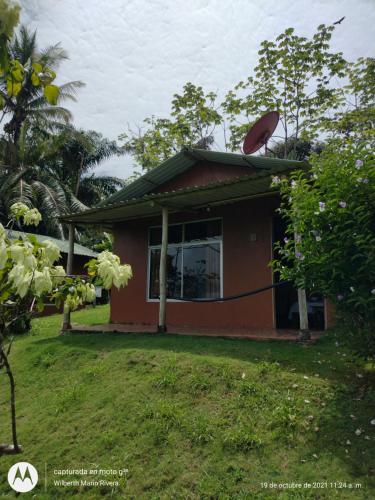 a small red house with a window on top of it at Hotel Mirador Osa in Mogos