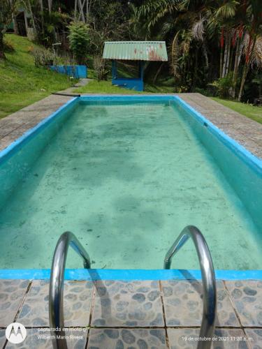 a pool of water with two metal handles in it at Hotel Mirador Osa in Mogos